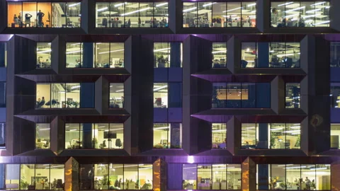 View of office windows with working people Stock Footage 142302459