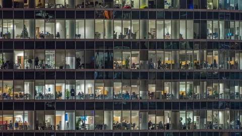 View of office windows with working people Stock Footage 143069359
