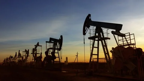 View of oil pump jacks at sunset in Russia. Video stock 344394635
