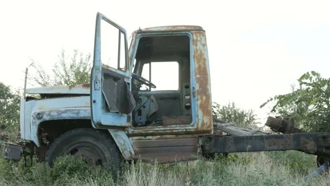 View of old broken vehicle rusting on the field Stock Footage 104482685