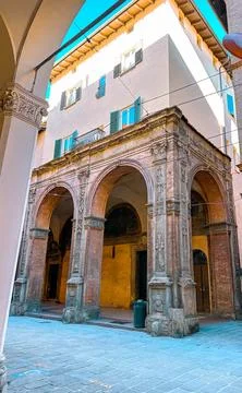 View of old building facade with arched column in Bologna, Italy. Stock Photos