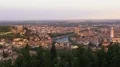 View of old city with river in middle, towers rising up over rooftops, panorama HD Footage