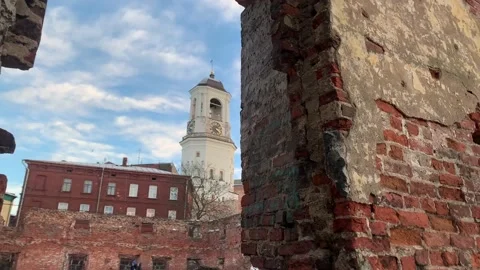 View of the old clock tower among the old brick ruins Video stock 229798209