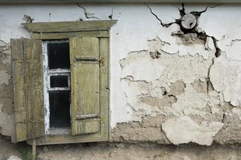 View of an old house with open window shutters on the left Stock Photos