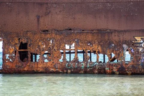 View of an old rusty shipwreck in the ocean. Fotos de archivo