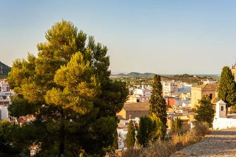 View to the old town from the hill surrounded by fields, trees and mountains Stock Photos