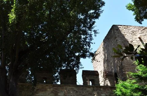 View of the old white stone wall and tower. Stock Photos