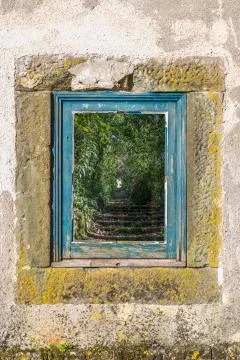 View of old window with frames in blue wood, glass with reflection of a stair Stock Photos