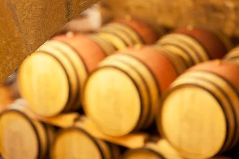 View in an old wine cellar with blurred wine barrels in the background - sele Stock Photos