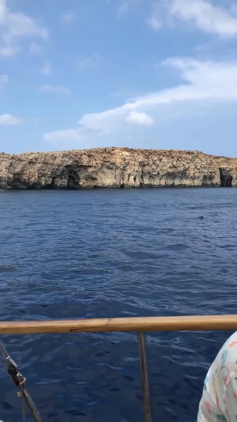 View from one sailboat as it passes another off the coast of Malta Stock Footage 124999792