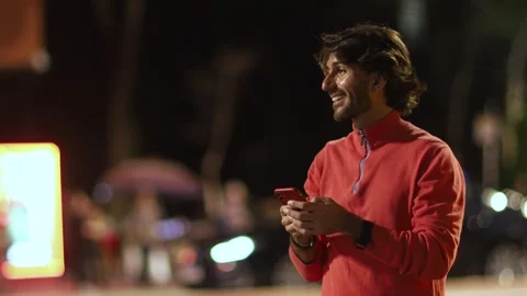View of one young caucasian man with smartphone at night time Stock Footage 264175191