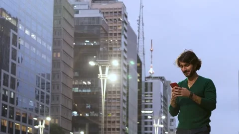 View of one young caucasian man with smartphone at night time Stock Footage 267705790