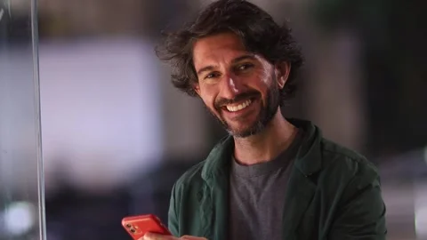 View of one young caucasian man with smartphone at night time Stock Footage 268812264