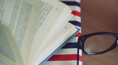 View of the open book lying on the folder next to the glasses Stock Footage 61193882