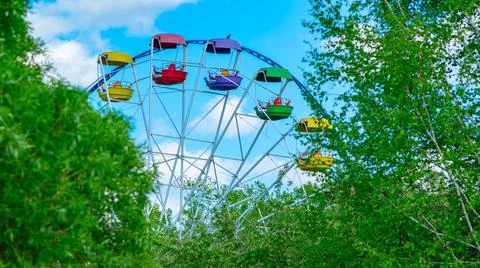 View of open colored Ferris wheel booths of the city park Stock Photos