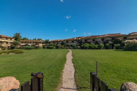View from the open gate of the path across the lawn to the cottages Stock Photos