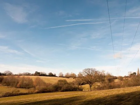 View of open green empty grass fields outside spring dedham vale landscape Stock Photos
