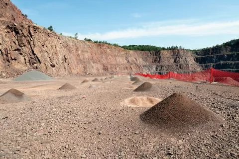 View into an open pit mine with prophyry rock material Stock Photos