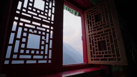 View from open red window in buddhist monastery, mountains in blue mist outside Stock Footage 167532764