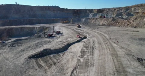 View of at opencast mining pit with lots of machinery escavators and trucks Stock Footage 245504560