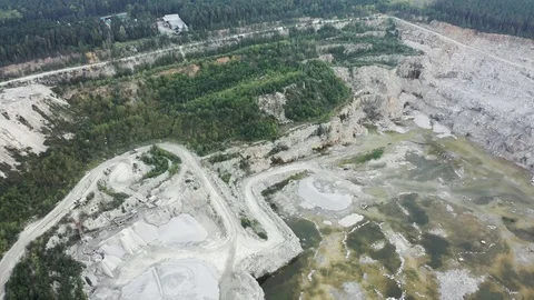 View of opencast mining quarry with lots of machinery. Mining in the granite Stock Footage 113532088