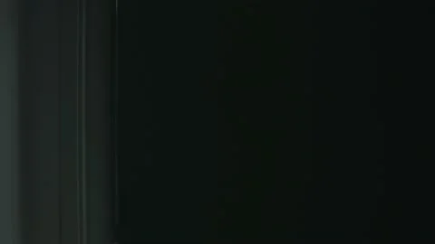 View of the operating room through a transparent door. surgeons perform the Stock-Footage 143458418