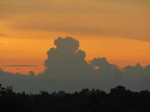 View of orange sky with dark clouds Stock Photos