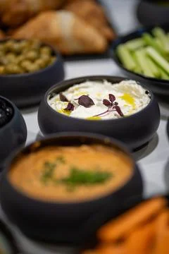 View of an ornately decorated table displaying an array of sauces in bowls Foto stock