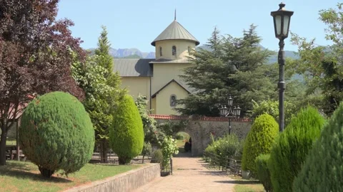 View of the orthodox monastic complex, park and mountains Stock Footage 280362883