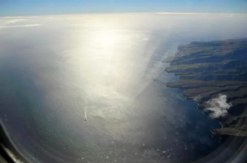 View out of a airplan to the surface of ocean and iland Tenerife Stock Photos