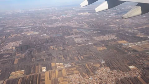 View out airplane window landscape with fields. Concept of traveling by air. Stock-Footage 332322489