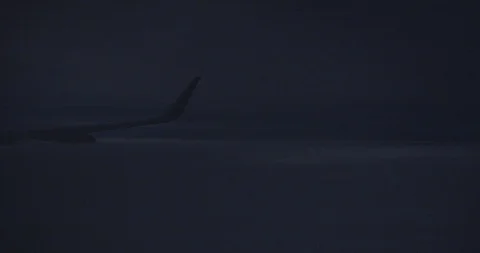 View out of a Airplane window at night over the clouds - Fly in the storm Video stock 121803146