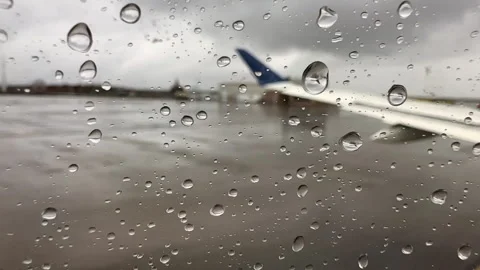 View out of an airplane window on a rainy day Stock Footage 335708314