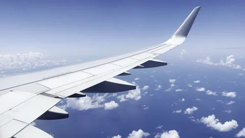 View out airplane window wing of tropical Caribbean Mexico coast blue sky clouds Stock Footage 194173298