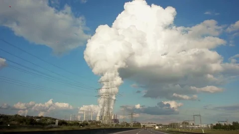 View out of car window passing by a cooling towers of nuclear power plant or Stock Footage 84887648