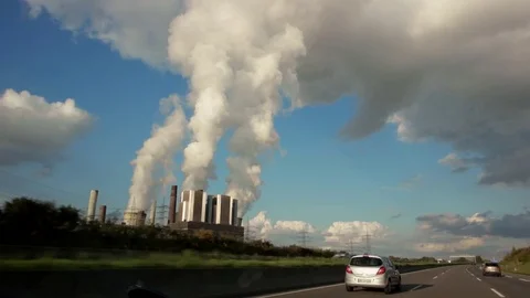 View out of car window passing by a cooling towers of nuclear power plant or Stock Footage 84887810