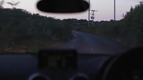 View out of the front of car while driving in the countryside at dusk Video stock 277403414