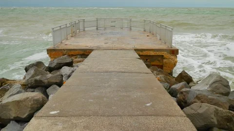 View out to the Gulf of Mexico over a pier at  Pass-a-Grille in St. Pete Beach,  Stock Footage 299921706