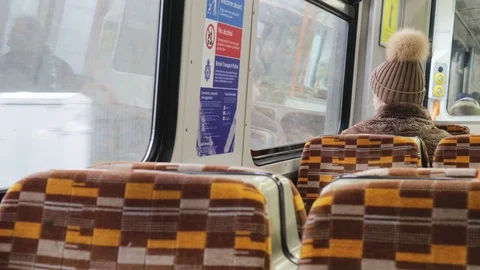 View Out Of London Overground Train Carriage Woman Looking Out Of Window Video stock 102640187