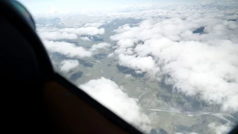 View out of a plane over clouds and mountains 動画素材 92367589