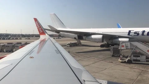 View out of plane window of planes being loaded Stock Footage 112126054
