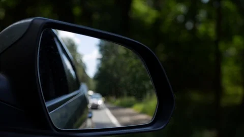 View out the rearview mirror as car drives on country road. 4K Stock Footage 101783739