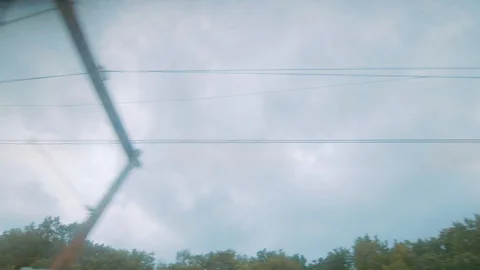View out a train window of the cabling along the track Stock Footage 92768687