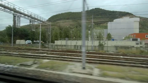 View out from Train Window - passing Mountain. Travel Europe / Italy Stock Footage 131402056