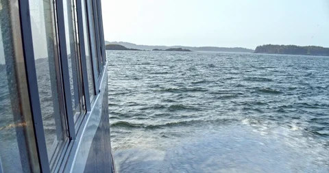 View from out the window of an ocean boat making waves as it moves through the Stock Footage 120698757