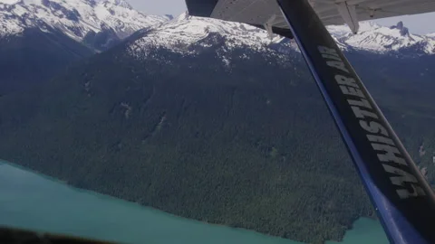 View out window of sea plane tour in Whistler Canada of turquoise blue lake Stock Footage 204826395