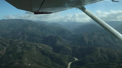 View Out Window Of Small Plane Flying Over Haiti Countryside Mountains Stock Footage 147294316