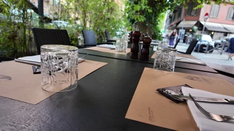 View of an outdoor table setting at a cozy Italian restaurant Stock Footage 341252949