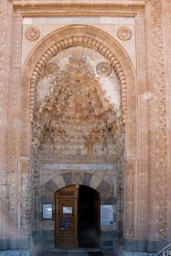 View of the outer gate of the historical Esrefoglu Mosque. The ornate main en Stock-Fotos