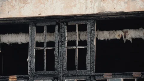 View from the outside of an abandoned charred building after a fire. burned-out Stock Footage 107855454